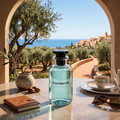 Louis Vuitton Imagination Eau de Parfum bottle displayed on a marble table overlooking a Mediterranean coastal landscape
