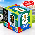 Panini FIFA World Cup 2026 collectible box displayed on a football field in a stadium, featuring World Cup trophy artwork and a “FREE SHIPPING” promotional badge.
